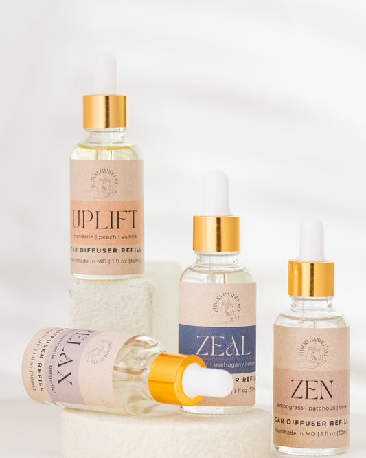 Set of four diffuser refills with visible branding on a light background
