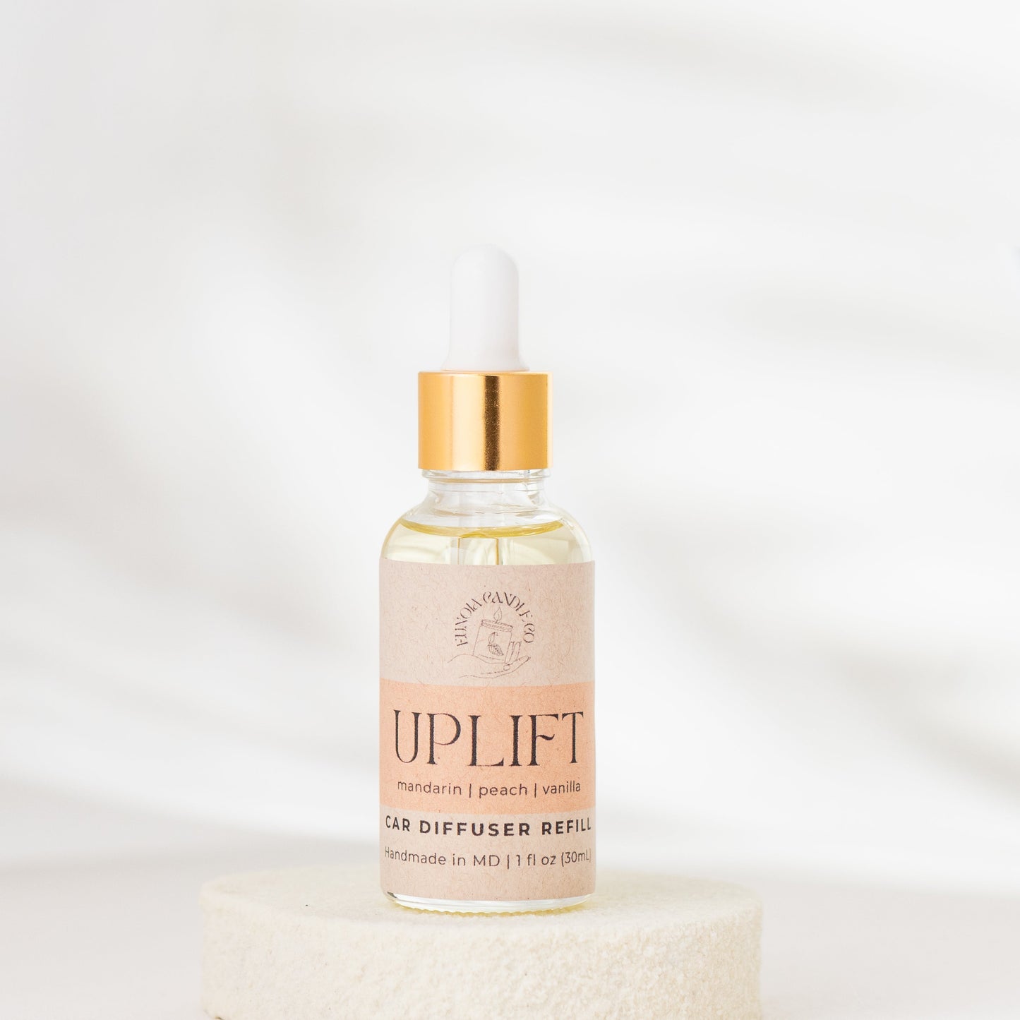 Bottle of 'Uplift' diffuser refill on a white background