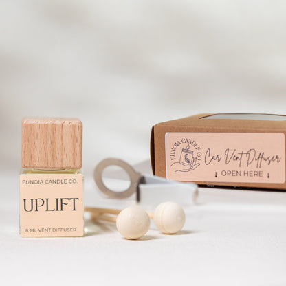 Eunica Candle Co. Uplift car diffuser bottle with packaging on a light background