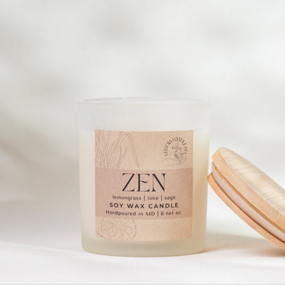 Candle labeled 'Zen' with a wooden lid on a neutral background