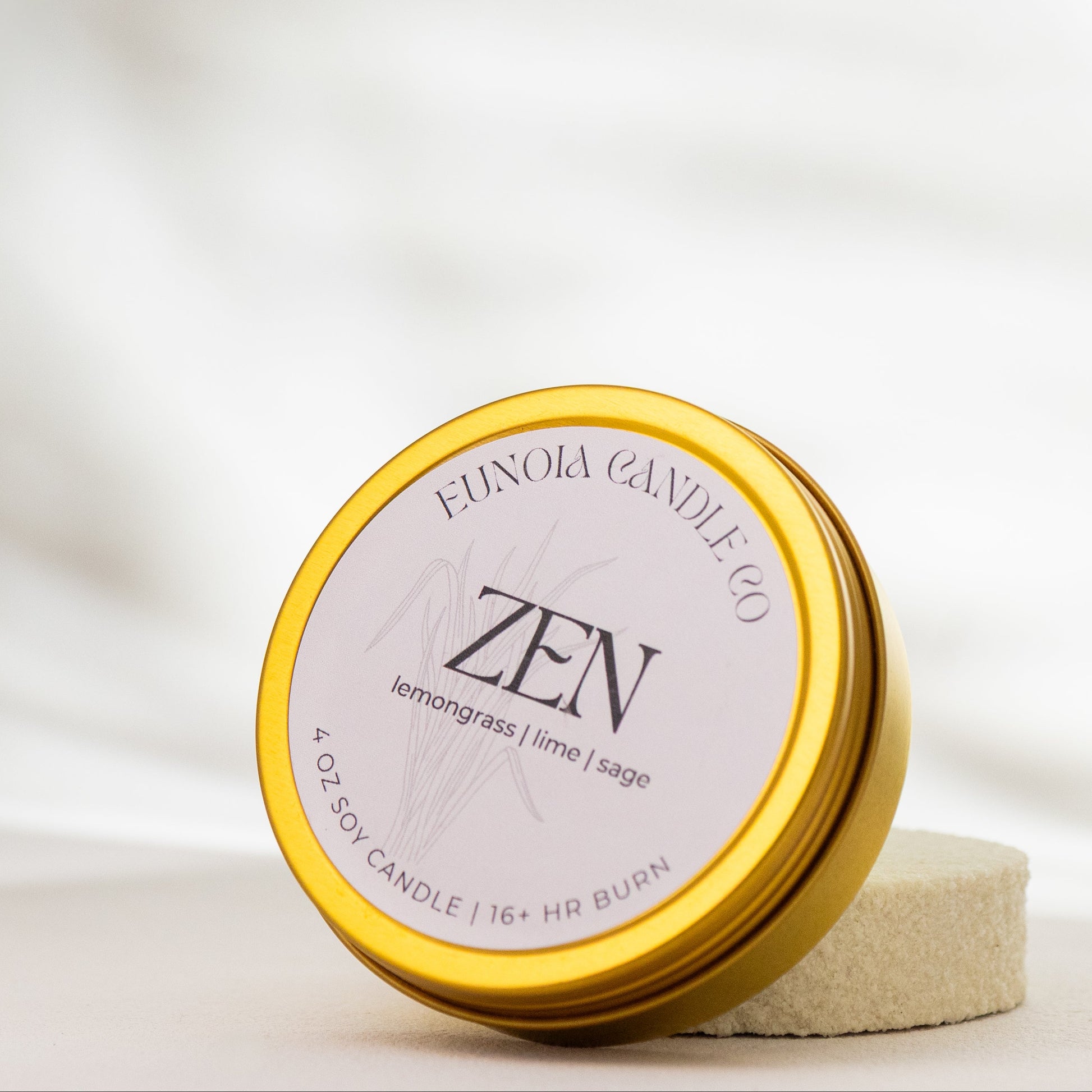 Gold candle tin with 'ZEN' label on a white background